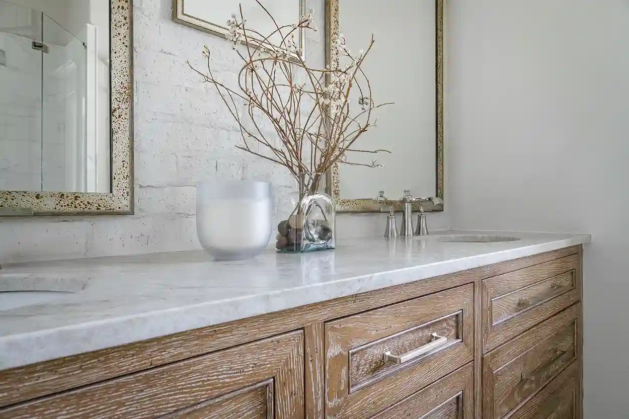 Rustic bathroom vanity with marble countertop and decorative vase with branches