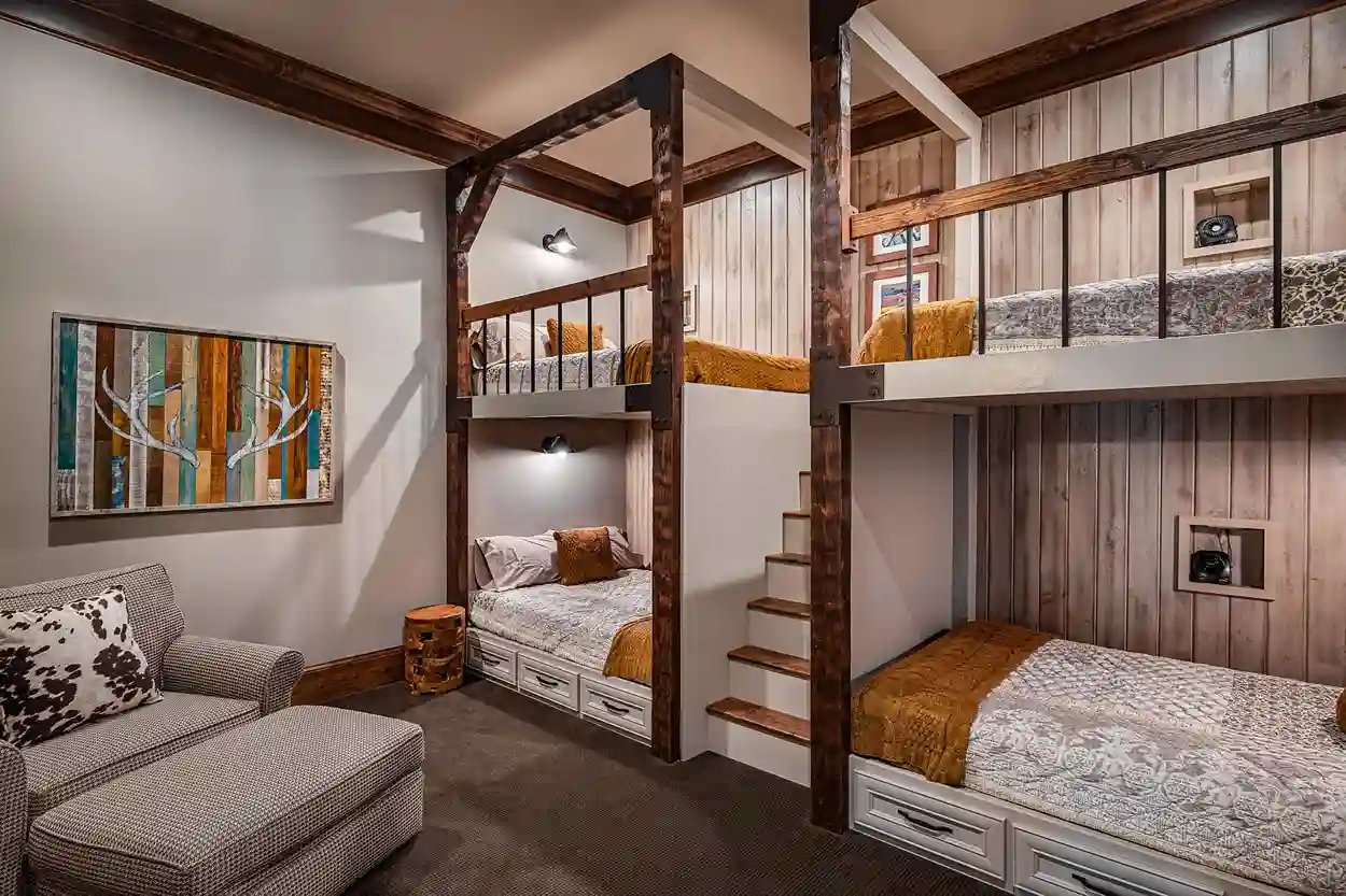Custom-built bunk beds with rustic wood finish in a cozy bedroom designed by Michael James Remodeling.