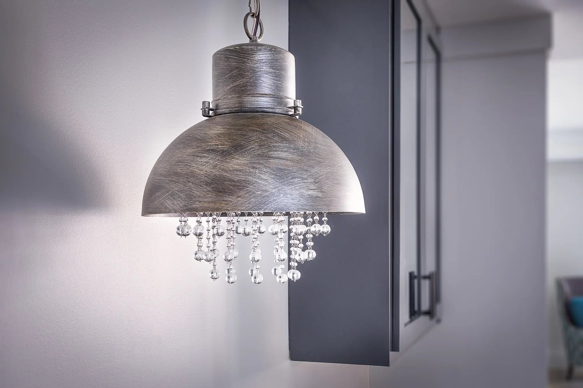 Stylish metal pendant light with crystal accents in a modern home interior