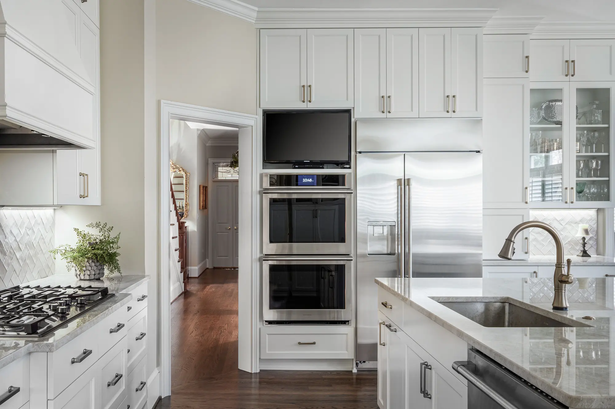 Traditional kitchen with Taj Mahal quartzite countertops and new cabinetry by Michael James Remodeling