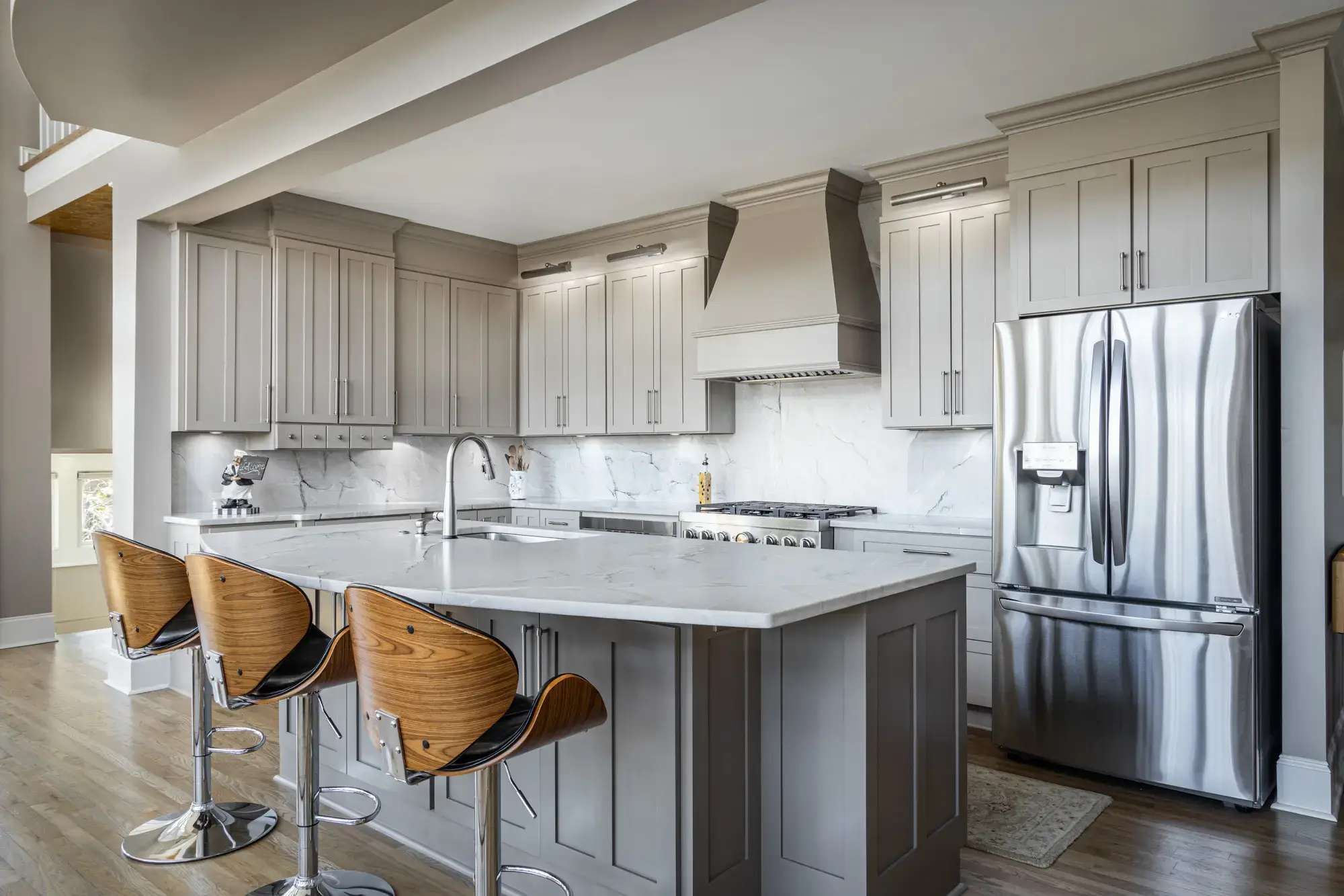 Traditional kitchen with a steel beam opening to a lake view, remodeled by Michael James Remodeling